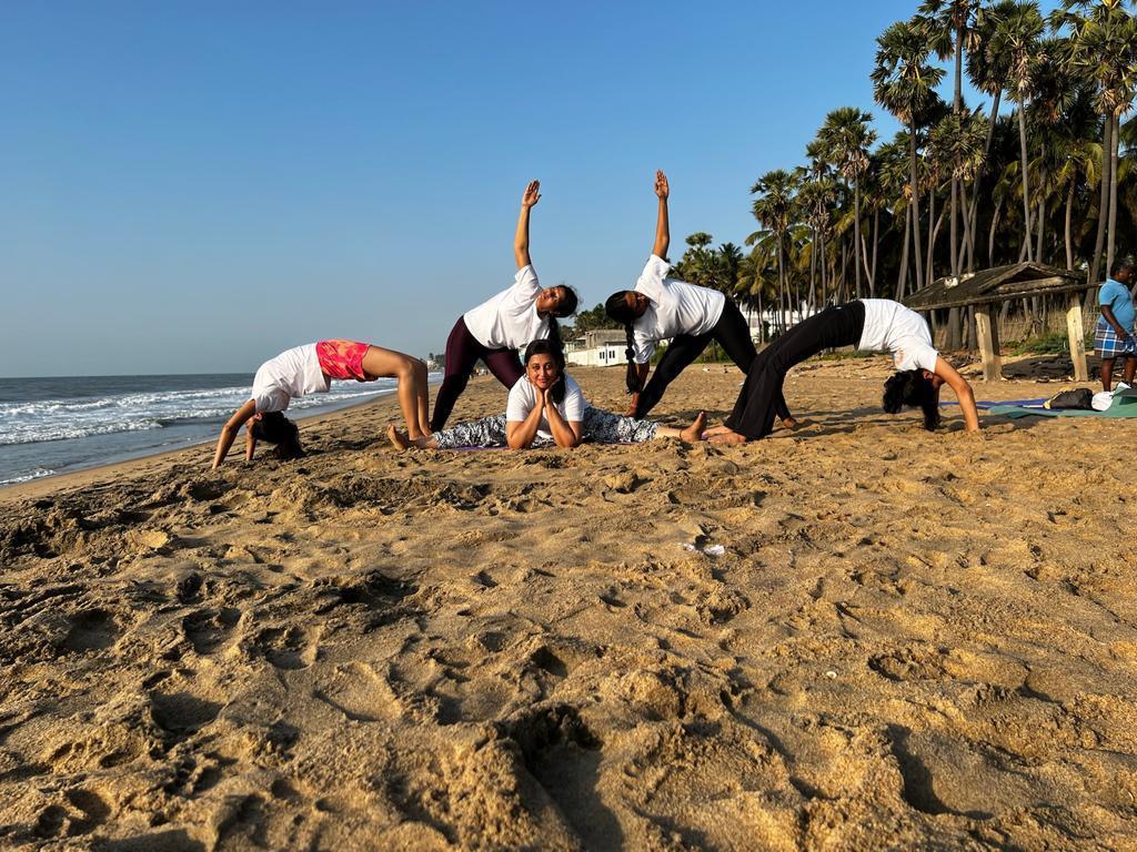 Students practicing yoga together in a bright studio